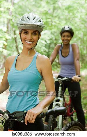 Two female cyclists in forest View Large Photo Image Stock Photography - Two female cyclists in forest. Fotosearch