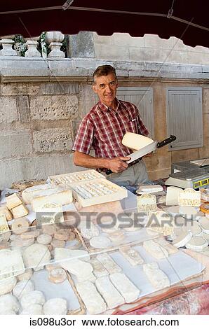 Man at sheeps cheese market stall in france View Large Photo Image Stock Photography - Man at sheeps cheese market stall in france. Fotosearch