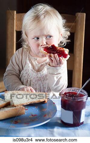 Female toddler eating bread and jam View Large Photo Image Picture - Female toddler eating bread and jam. Fotosearch