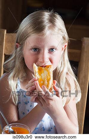 Girl eating bread View Large Photo Image Stock Image - Girl eating bread. Fotosearch