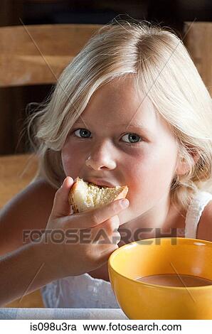 Stock Image - Girl eating bread. Fotosearch