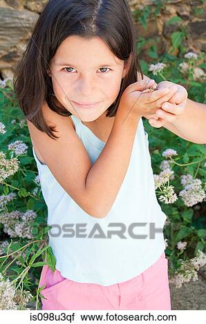 Girl holding butterfly View Large Photo Image Stock Image - Girl holding butterfly. Fotosearch