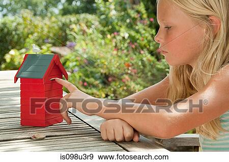 Girl touching red birdbox View Large Photo Image Stock Photo - Girl touching red birdbox. Fotosearch