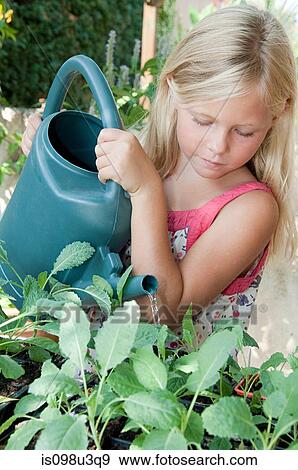 Stock Photo - Girl watering plants. Fotosearch
