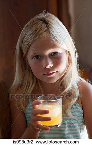 Girl with glass of orange juice View Large Photo Image Stock Image - Girl with glass of orange juice. Fotosearch