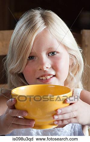 Stock Image - Girl with hot drink in bowl. Fotosearch