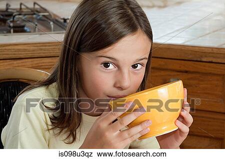 Stock Photo - Girl with hot drink in bowl. Fotosearch
