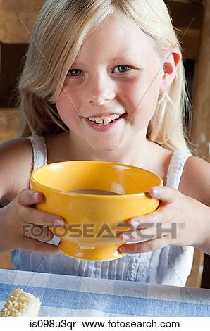 Stock Photography - Girl with hot drink in bowl. Fotosearch