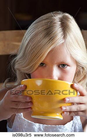 Stock Photography - Girl with hot drink in bowl. Fotosearch