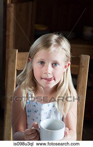 Stock Image - Girl with hot drink in mug. Fotosearch