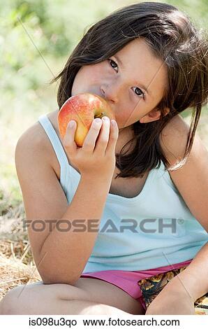 Girls eating apple View Large Photo Image Picture - Girls eating apple. Fotosearch