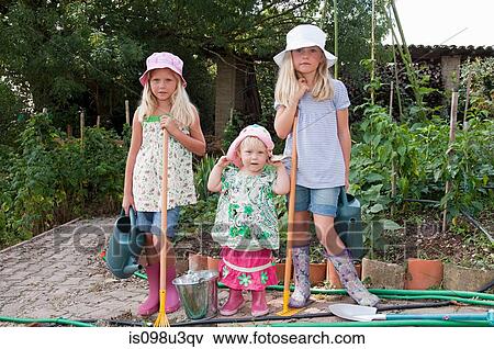 Girls gardening in vegetable garden View Large Photo Image Stock Photo - Girls gardening in vegetable garden. Fotosearch