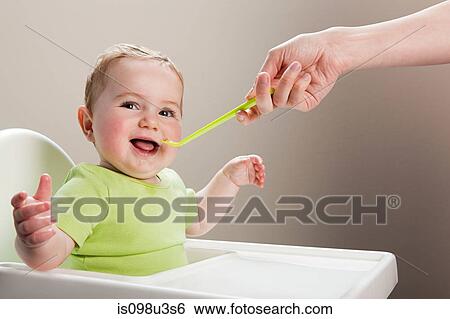 Baby boy being spoon fed View Large Photo Image Stock Photograph - Baby boy being spoon fed. Fotosearch