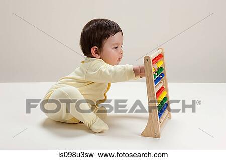 Baby boy playing with abacus View Large Photo Image Stock Photo - Baby boy playing with abacus. Fotosearch