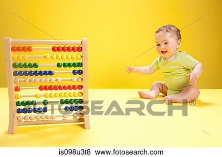 Stock Photo - Baby boy playing with abacus. Fotosearch