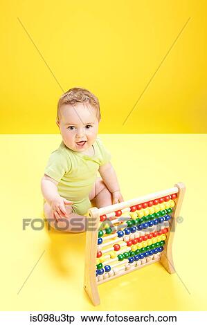 Baby boy playing with abacus View Large Photo Image Stock Photography - Baby boy playing with abacus. Fotosearch