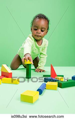Baby boy playing with building blocks View Large Photo Image Stock Image - Baby boy playing with building blocks. Fotosearch