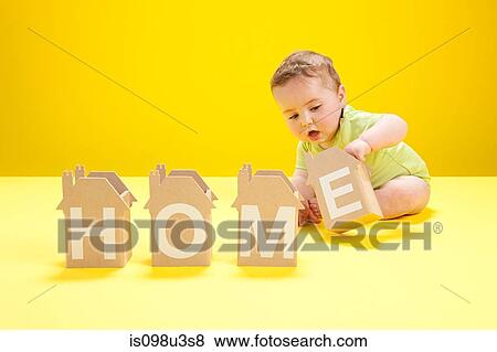 Baby boy playing with cardboard houses View Large Photo Image Stock Photo - Baby boy playing with cardboard houses. Fotosearch