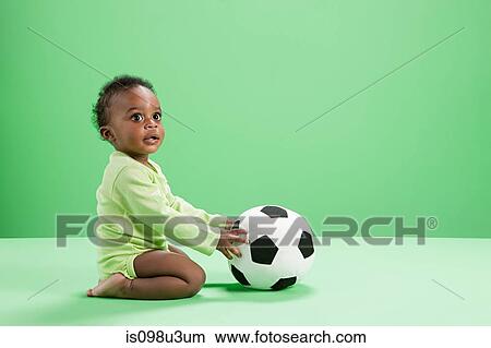 Baby boy playing with football View Large Photo Image Picture - Baby boy playing with football. Fotosearch