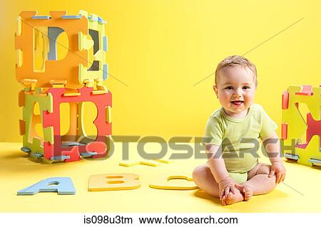Baby boy playing with toy alphabet letters View Large Photo Image Picture - Baby boy playing with toy alphabet letters. Fotosearch