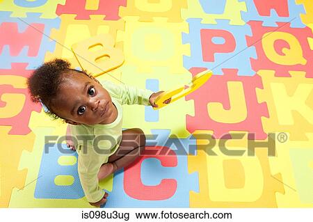 Baby boy playing with toy alphabet letters View Large Photo Image Stock Image - Baby boy playing with toy alphabet letters. Fotosearch