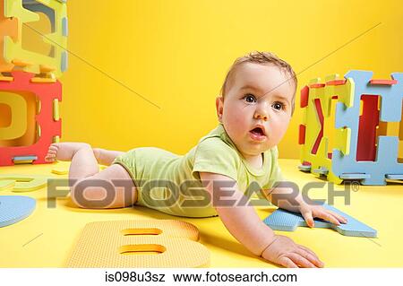 Stock Photo - Baby boy playing with toy alphabet letters. Fotosearch