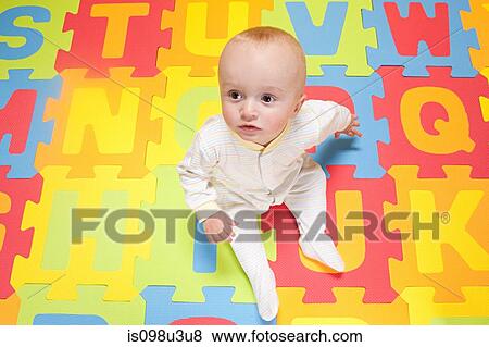 Baby boy playing with toy alphabet letters View Large Photo Image Stock Photo - Baby boy playing with toy alphabet letters. Fotosearch