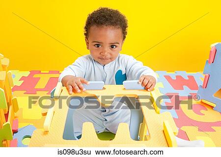 Baby boy playing with toy alphabet letters View Large Photo Image Stock Photograph - Baby boy playing with toy alphabet letters. Fotosearch