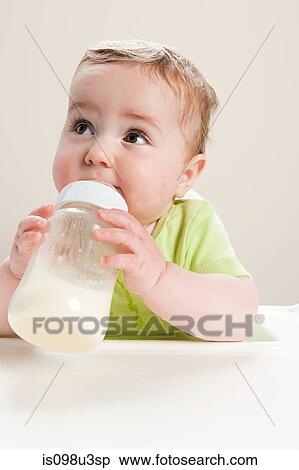 Baby boy with bottle of milk View Large Photo Image Stock Photography - Baby boy with bottle of milk. Fotosearch