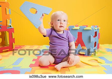 Baby girl playing with toy alphabet letters View Large Photo Image Stock Image - Baby girl playing with toy alphabet letters. Fotosearch