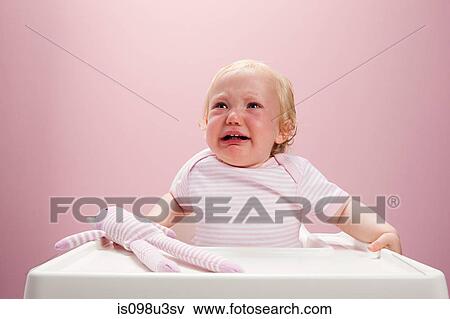 Baby girl sitting in highchair crying View Large Photo Image Stock Photo - Baby girl sitting in highchair crying. Fotosearch