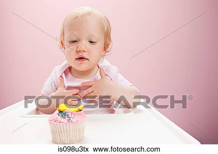 Baby girl with cupcake View Large Photo Image Stock Photo - Baby girl with cupcake. Fotosearch