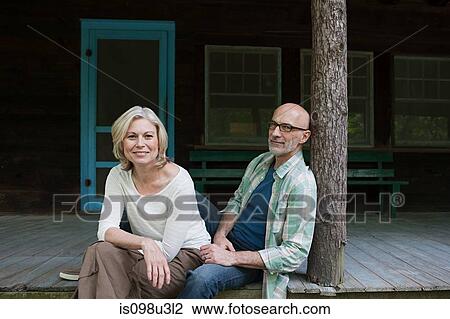 Stock Image - Mature couple at rural retreat. Fotosearch