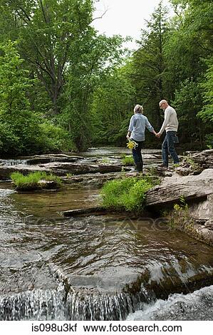 Stock Image - Mature couple outdoors in rural scene. Fotosearch