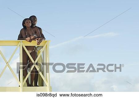 Stock Image - Couple at beach house. Fotosearch