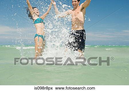 Couple having fun in the sea View Large Photo Image Stock Photo - Couple having fun in the sea. Fotosearch