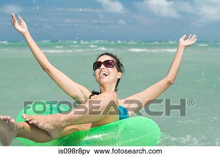 Happy woman in sea on inflatable ring View Large Photo Image Stock Photo - Happy woman in sea on inflatable ring. Fotosearch