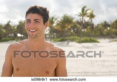 Young man at beach View Large Photo Image Stock Image - Young man at beach. Fotosearch