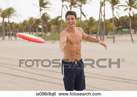 Young man throwing flying disc View Large Photo Image Stock Photograph - Young man throwing flying disc. Fotosearch