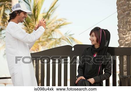 Stock Image - Middle Eastern man taking photograph. Fotosearch
