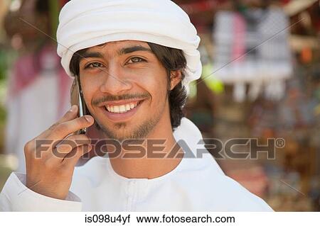 Stock Image - Middle Eastern man using mobile phone. Fotosearch