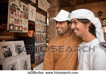 Middle Eastern men looking at pictures View Large Photo Image Stock Photo - Middle Eastern men looking at pictures. Fotosearch