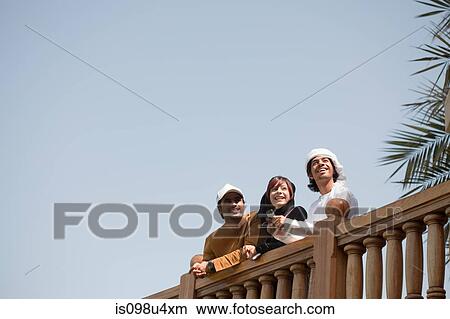 Picture - Middle Eastern people and fence, low angle view. Fotosearch