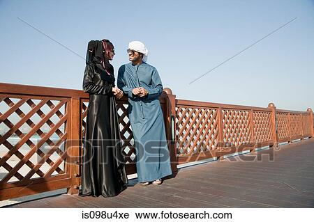 Stock Image - Middle Eastern people and fence, outdoors. Fotosearch