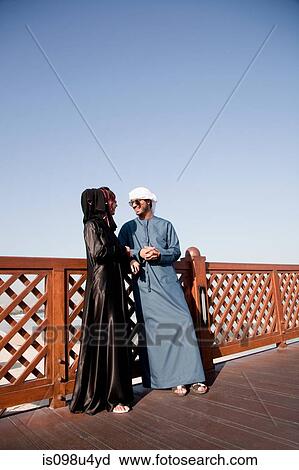 Stock Image - Middle Eastern people and fence, outdoors. Fotosearch