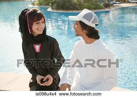 Middle Eastern people by swimming pool View Large Photo Image Picture - Middle Eastern people by swimming pool. Fotosearch