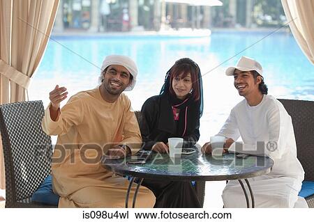 Middle Eastern people sitting at table outdoors View Large Photo Image Stock Image - Middle Eastern people sitting at table outdoors. Fotosearch