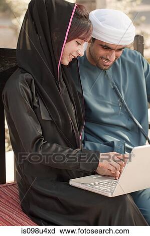 Stock Image - Middle Eastern people using laptop. Fotosearch