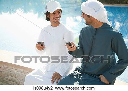 Two Middle Eastern men with mobile phones View Large Photo Image Stock Image - Two Middle Eastern men with mobile phones. Fotosearch
