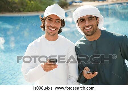 Two Middle Eastern men with mobile phones View Large Photo Image Stock Photograph - Two Middle Eastern men with mobile phones. Fotosearch